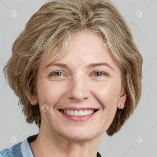 Joyful white adult female with medium  brown hair and blue eyes