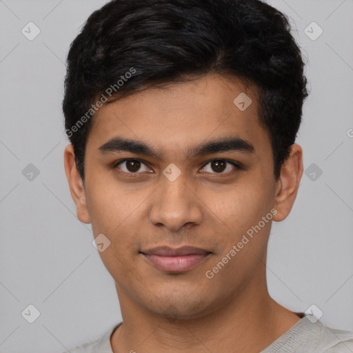 Joyful latino young-adult male with short  black hair and brown eyes