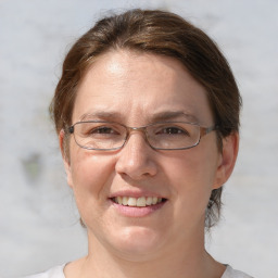 Joyful white adult female with medium  brown hair and grey eyes