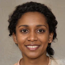 Joyful black young-adult female with medium  brown hair and brown eyes