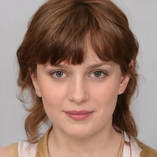 Joyful white child female with medium  brown hair and grey eyes