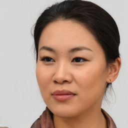 Joyful asian young-adult female with medium  brown hair and brown eyes