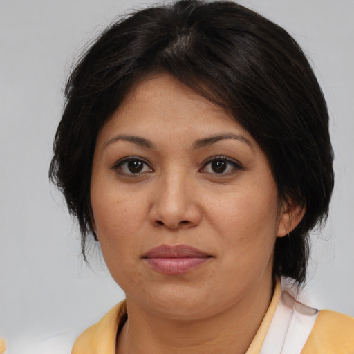 Joyful asian young-adult female with medium  brown hair and brown eyes