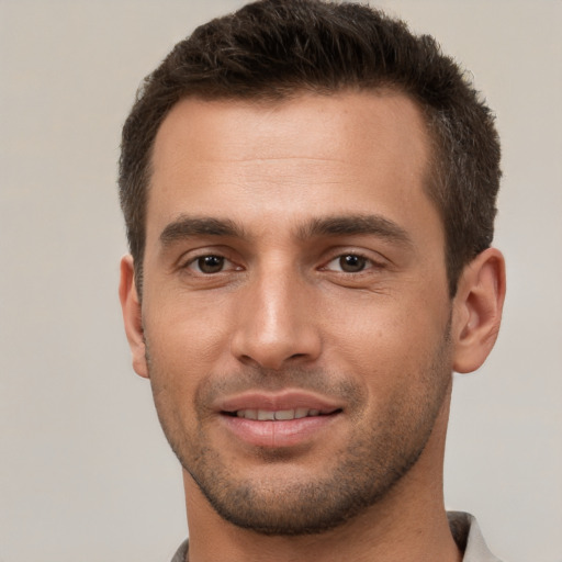 Joyful white young-adult male with short  brown hair and brown eyes