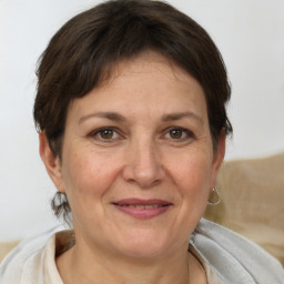 Joyful white adult female with short  brown hair and brown eyes