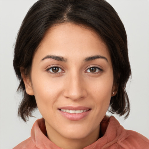 Joyful white young-adult female with medium  brown hair and brown eyes