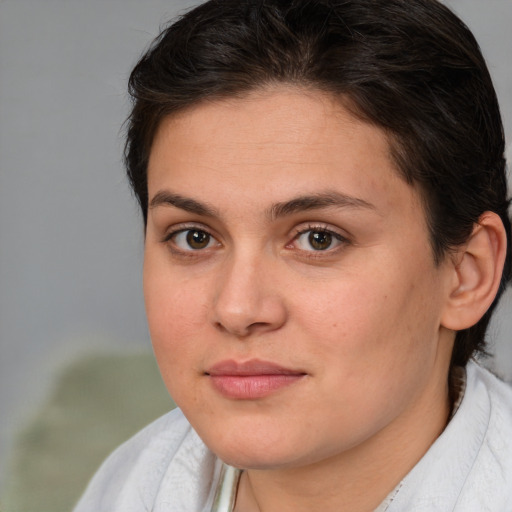 Joyful white young-adult female with medium  brown hair and brown eyes