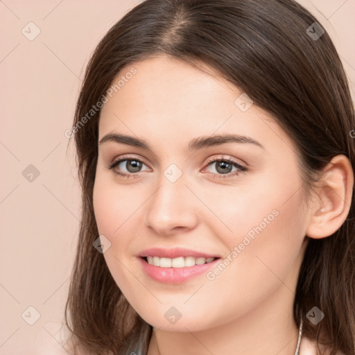 Joyful white young-adult female with long  brown hair and brown eyes