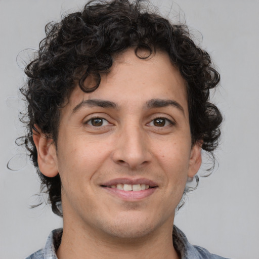 Joyful white adult male with medium  brown hair and brown eyes