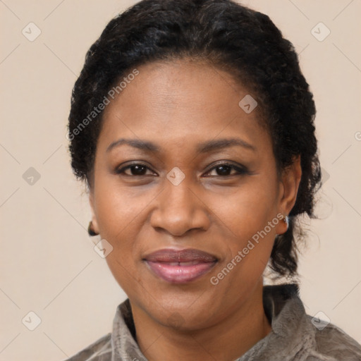 Joyful black adult female with short  black hair and brown eyes