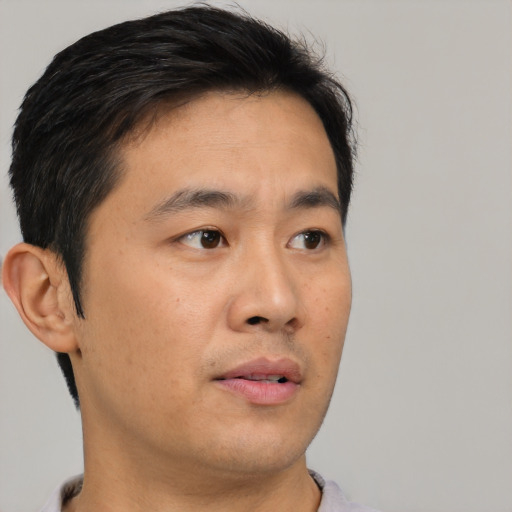 Neutral asian young-adult male with short  brown hair and brown eyes