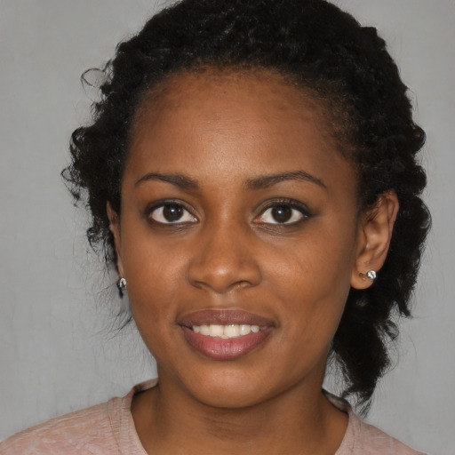 Joyful black young-adult female with medium  brown hair and brown eyes
