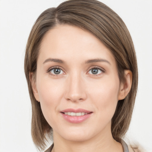 Joyful white young-adult female with medium  brown hair and grey eyes