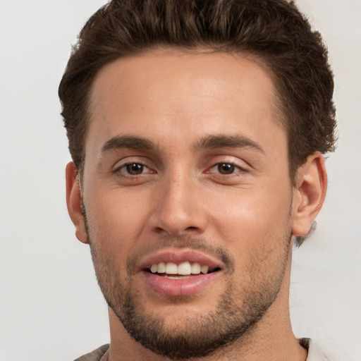 Joyful white young-adult male with short  brown hair and brown eyes