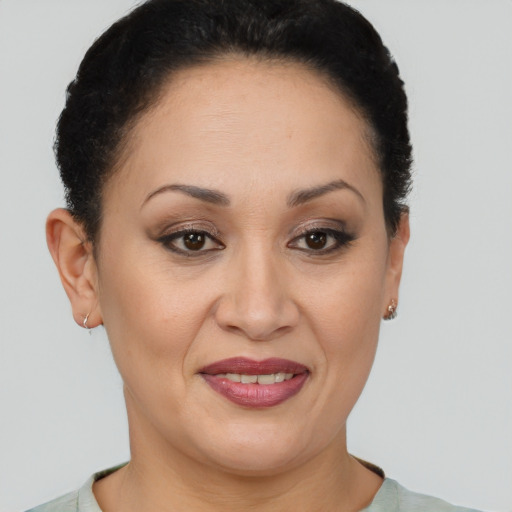 Joyful latino adult female with short  brown hair and brown eyes