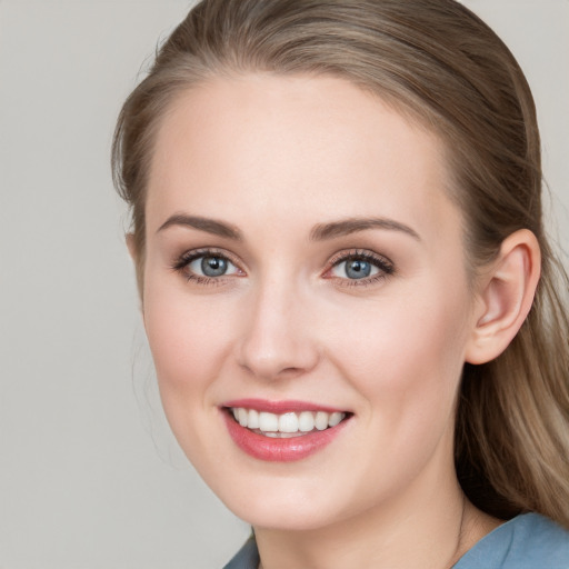 Joyful white young-adult female with long  brown hair and blue eyes