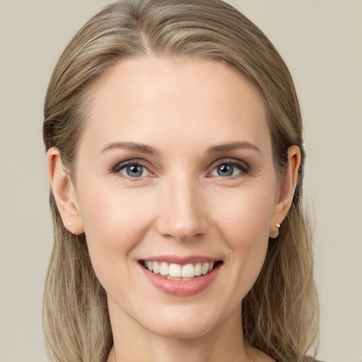 Joyful white young-adult female with long  brown hair and green eyes