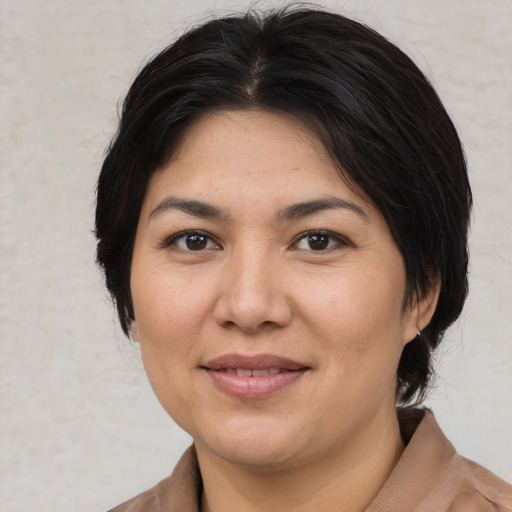Joyful asian adult female with medium  black hair and brown eyes