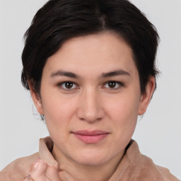 Joyful white young-adult female with medium  brown hair and brown eyes