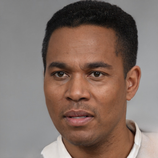 Neutral black young-adult male with short  black hair and brown eyes