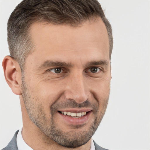 Joyful white adult male with short  brown hair and brown eyes