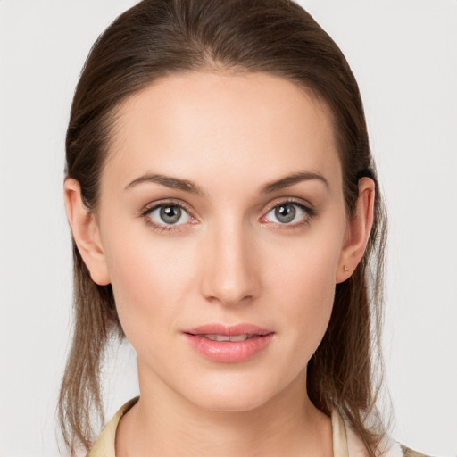 Joyful white young-adult female with medium  brown hair and grey eyes