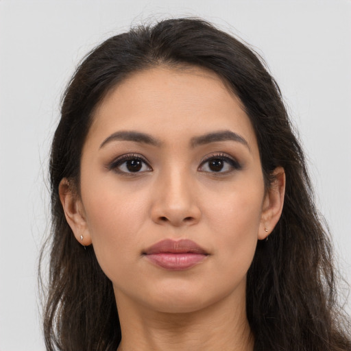 Neutral latino young-adult female with long  brown hair and brown eyes