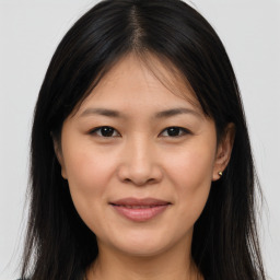 Joyful asian young-adult female with long  brown hair and brown eyes