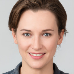 Joyful white young-adult female with medium  brown hair and grey eyes