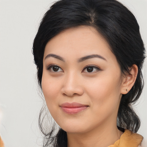 Joyful asian young-adult female with long  black hair and brown eyes