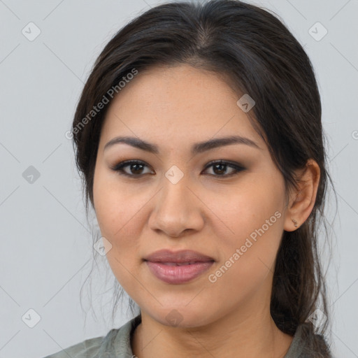 Joyful latino young-adult female with medium  brown hair and brown eyes