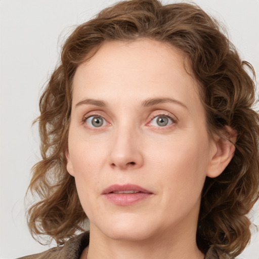 Joyful white young-adult female with medium  brown hair and blue eyes