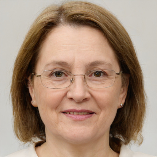 Joyful white middle-aged female with medium  brown hair and green eyes