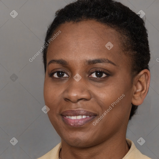 Joyful black young-adult female with short  brown hair and brown eyes