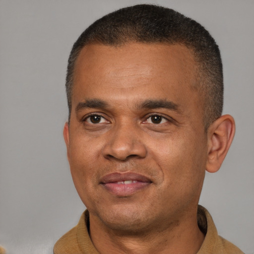 Joyful latino adult male with short  brown hair and brown eyes