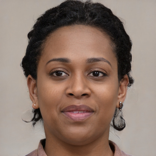Joyful black young-adult female with medium  brown hair and brown eyes
