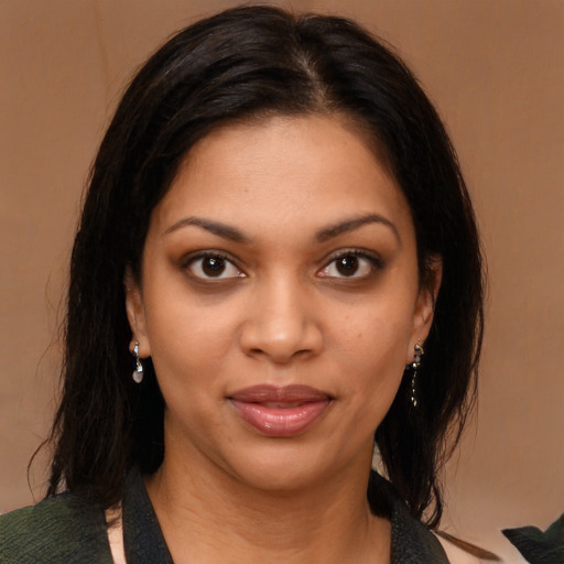 Joyful black young-adult female with medium  brown hair and brown eyes