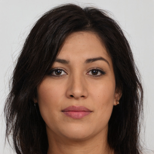 Joyful latino young-adult female with long  brown hair and brown eyes