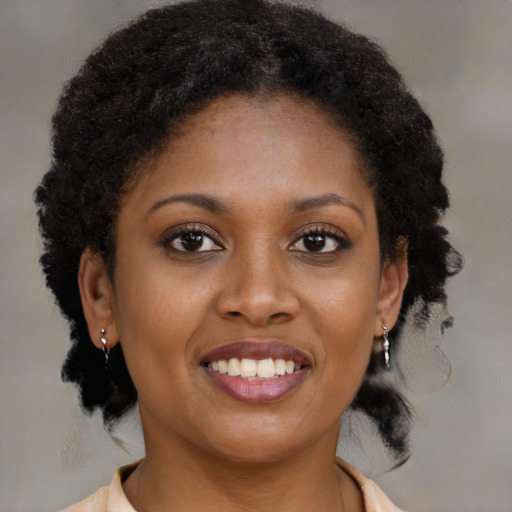 Joyful black young-adult female with medium  brown hair and brown eyes
