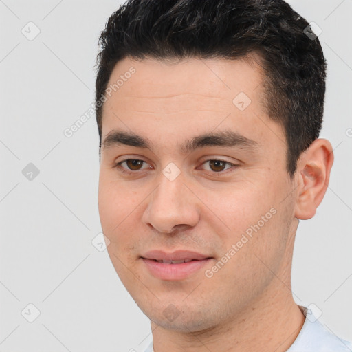 Joyful white young-adult male with short  black hair and brown eyes