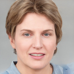 Joyful white adult female with medium  brown hair and blue eyes