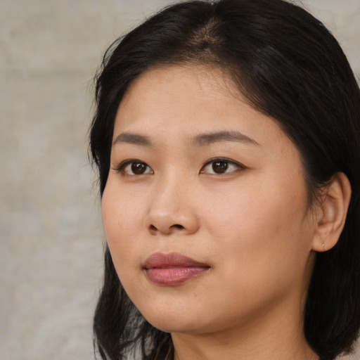 Joyful asian young-adult female with medium  brown hair and brown eyes