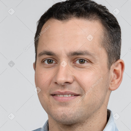 Joyful white adult male with short  brown hair and brown eyes