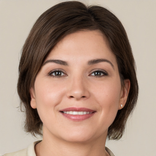 Joyful white young-adult female with medium  brown hair and brown eyes