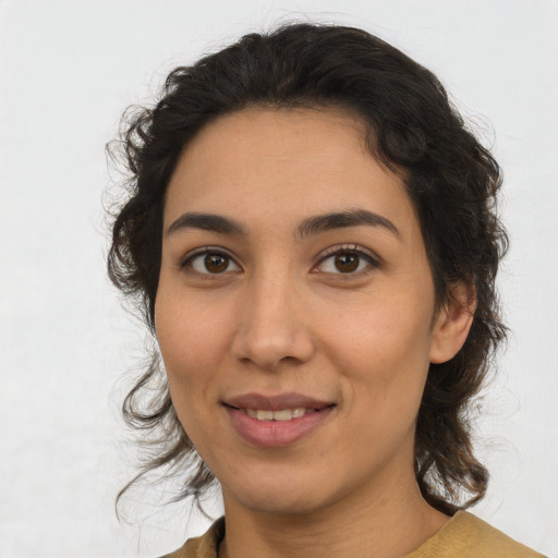 Joyful latino young-adult female with medium  brown hair and brown eyes