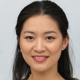 Joyful asian young-adult female with medium  brown hair and brown eyes