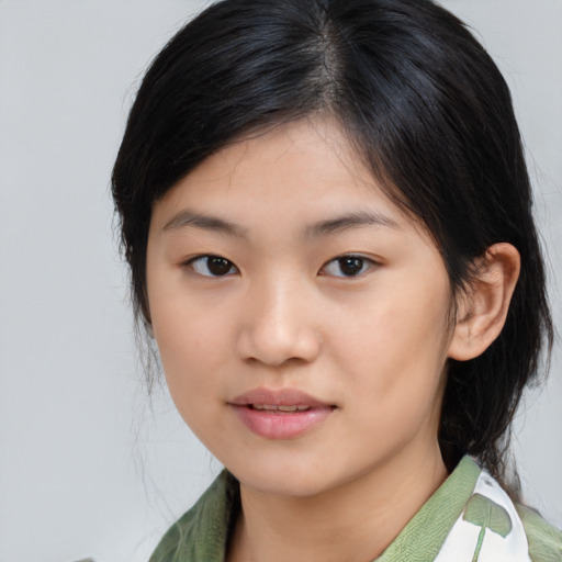Joyful asian young-adult female with medium  black hair and brown eyes