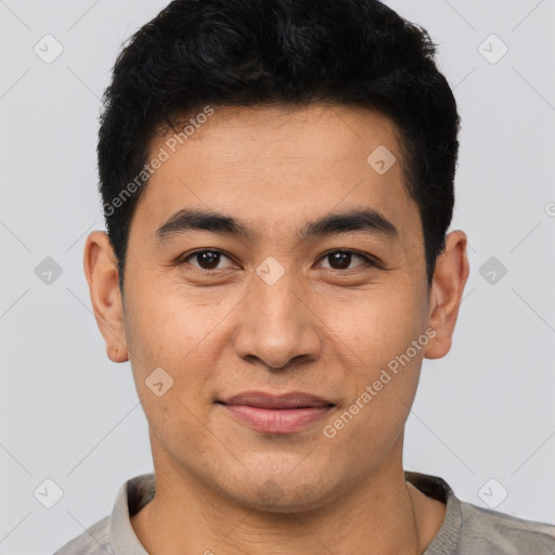 Joyful asian young-adult male with short  black hair and brown eyes