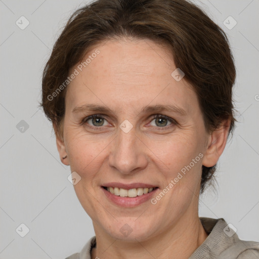 Joyful white adult female with medium  brown hair and grey eyes