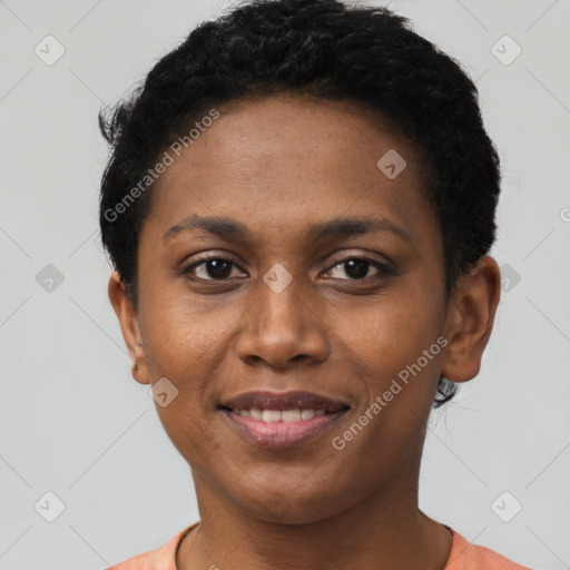 Joyful black young-adult female with short  brown hair and brown eyes